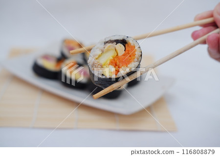 Sushi rolls on a plate on a white background. Japanese food Sushi rolls on a plate on a white background. Japanese food 116808879
