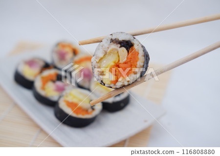 Sushi rolls on a plate on a white background. Japanese food Sushi rolls on a plate on a white background. Japanese food 116808880