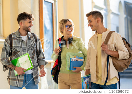 Cheerful woman with two male student, happily discussing their studying 116809072