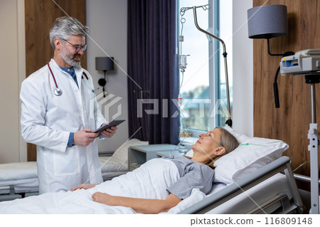 Male doctor examining a patient in an intensive therapy department 116809148