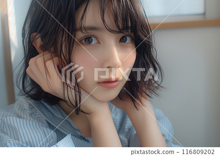 A girl with black bob hair wearing a light blue sleeveless top 116809202