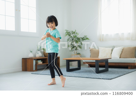A child stretching in the living room A child stretching in the living room 116809400
