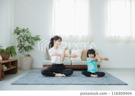 A child stretching in the living room A child stretching in the living room 116809404