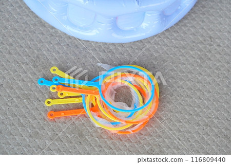 We enjoyed scooping up super balls at home. Here's a torn bundle of poi after we were done playing. 116809440