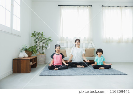 Family exercising in the living room Family exercising in the living room 116809441