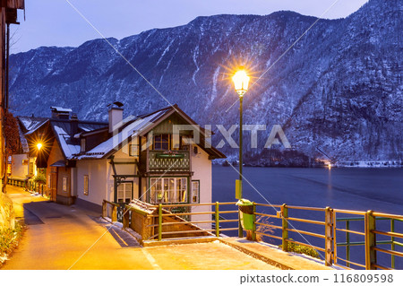 The famous Austrian village of Hallstatt on the shore of a lake at sunset. 116809598