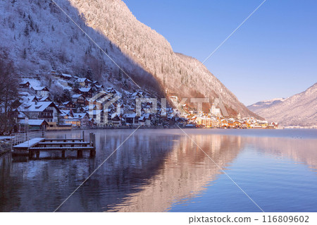 The famous Austrian village Hallstatt on the shore of a lake at dawn. The famous Austrian village Hallstatt on the shore of a lake at dawn. 116809602