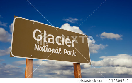 Glacier National Park (Montana) Road Sign Against Blue Sky and Clouds. 116809743