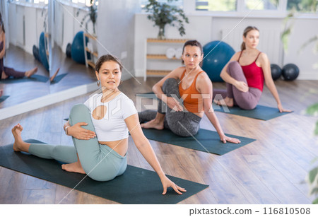 Girl teacher lead lesson, run training in female yoga studio and performs snail pose Girl teacher lead lesson, run training in female yoga studio and performs snail pose 116810508