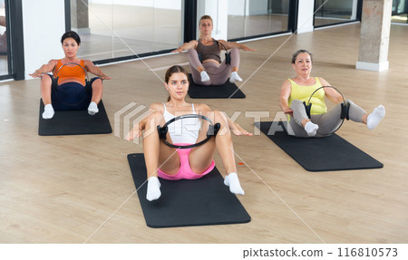 Women practice yoga with special circle for feet Women practice yoga with special circle for feet 116810573