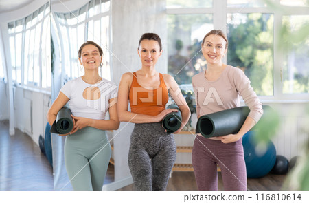 Report shot of girls visiting fitness center and yoga courses for beginners. 116810614