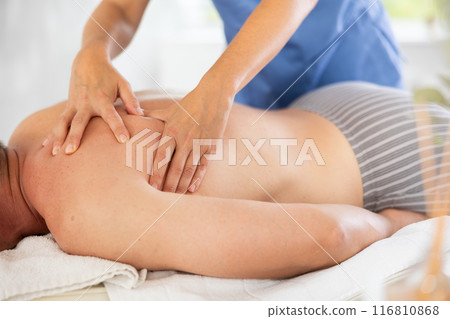 the client lies while the worker gives a massage 116810868