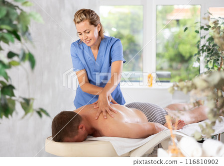 The masseur makes a massage to man The masseur makes a massage to man 116810902