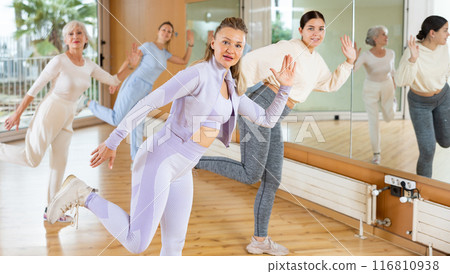 Positive people practicing vigorous lindy hop movements in dance class Positive people practicing vigorous lindy hop movements in dance class 116810938
