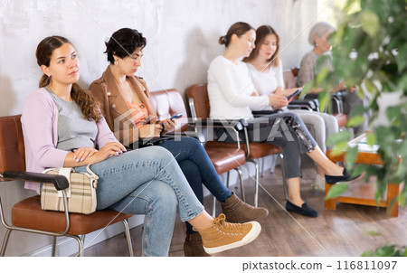 Young woman waiting for her turn on chair 116811097
