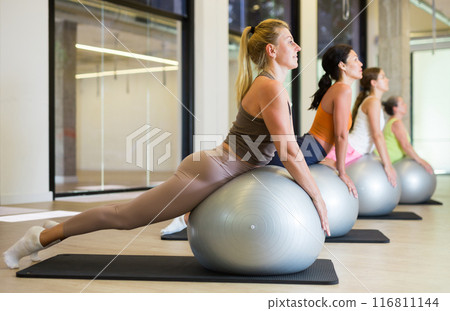 Portrait of women exercising on fitness ball 116811144