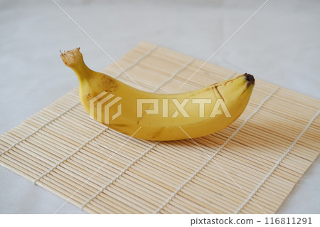 Bunch of bananas on a bamboo mat. Selective focus. Bunch of bananas on a bamboo mat. Selective focus. 116811291