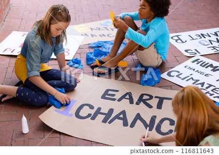 Happy diverse schoolchildren making ecology posters during outdoor school art class 116811643