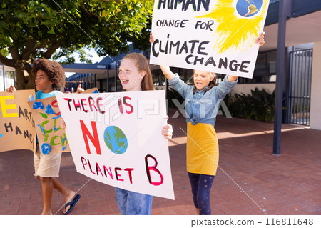 Happy diverse schoolchildren holding ecology posters made in art class outside school 116811648