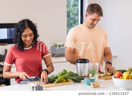 Preparing healthy meal, young couple chopping vegetables in modern kitchen Preparing healthy meal, young couple chopping vegetables in modern kitchen 116811837