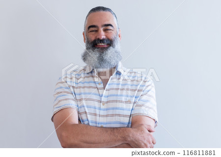 Smiling senior man with arms crossed, wearing striped shirt, looking confident Smiling senior man with arms crossed, wearing striped shirt, looking confident 116811881