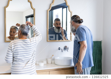 Grooming in bathroom, senior couple standing in front of mirrors 116812325