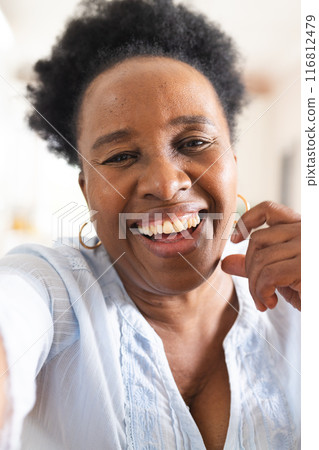 Portrait of happy senior african american woman having video call at home 116812479