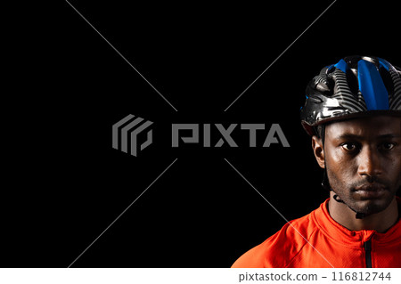 African American cyclist in gear, with copy space on a black background African American cyclist in gear, with copy space on a black background 116812744