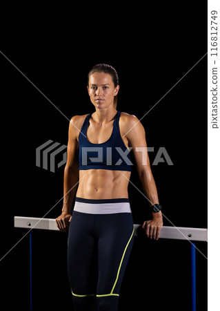 Athlete exudes strength and determination in gym setting. Athlete exudes strength and determination in gym setting. 116812749