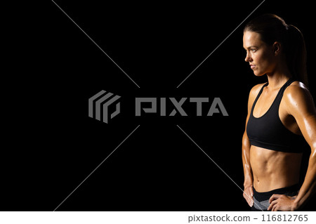 Athletic woman showcases health dedication on black background. 116812765