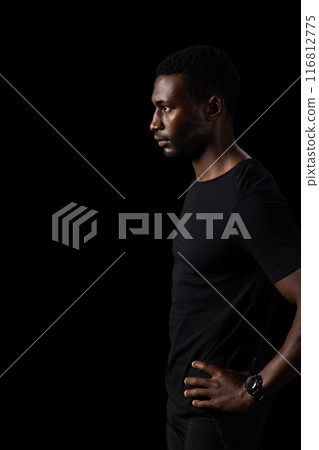 African American man in a contemplative pose, with copy space on a black background African American man in a contemplative pose, with copy space on a black background 116812775