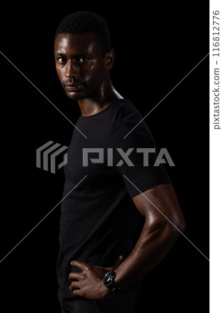 African American man poses confidently on a black background, with copy space 116812776