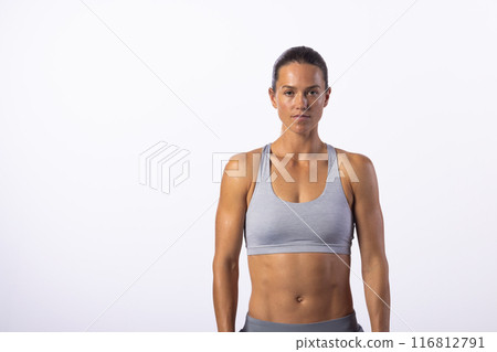 Young Caucasian woman stands confidently in fitness attire, with copy space Young Caucasian woman stands confidently in fitness attire, with copy space 116812791
