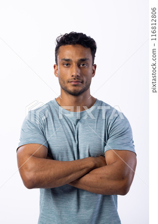 Confident young biracial man poses in a casual t-shirt, on a white background Confident young biracial man poses in a casual t-shirt, on a white background 116812806