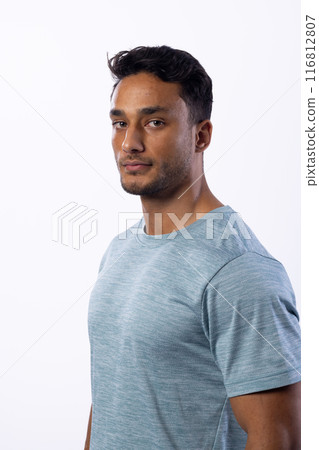 Young biracial man poses confidently in a casual shirt on a white background Young biracial man poses confidently in a casual shirt on a white background 116812807