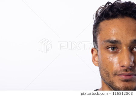 Close-up of a young biracial man, with copy space, on a white background Close-up of a young biracial man, with copy space, on a white background 116812808