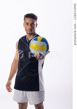 Athletic young biracial man poses with a volleyball on a white background 116812840
