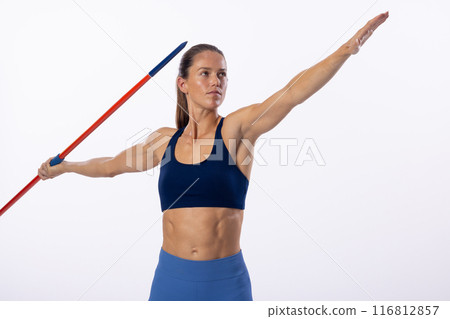 Young Caucasian female athlete prepares to throw a javelin on a white background 116812857