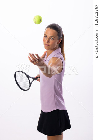 Young Caucasian woman poised to serve in a tennis match on a white background Young Caucasian woman poised to serve in a tennis match on a white background 116812867