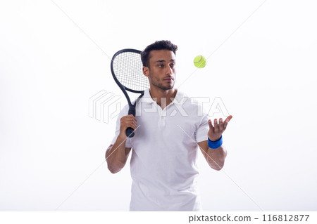 Young biracial man plays tennis indoors on a white background Young biracial man plays tennis indoors on a white background 116812877