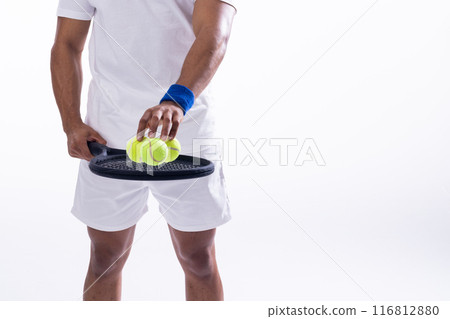 Biracial man prepares for a tennis match on a white background, with copy space 116812880