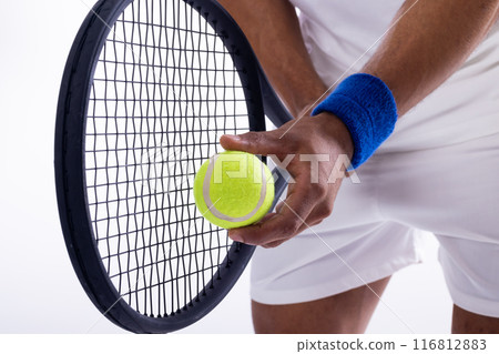 Close-up of a tennis player preparing to serve on a white background 116812883