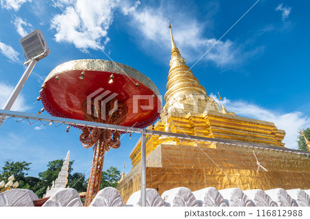 Beautiful gilded chedi in Wat Phra That Chae Hang the most important temple in Nan province of Thailand. The chedi contains a relic of the Buddha dating back to 14th century. Beautiful gilded chedi in Wat Phra That Chae Hang the most important temple in Nan province of Thailand. The chedi contains a relic of the Buddha dating back to 14th century. 116812988