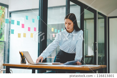Asian business woman working using laptop for do math finance on wooden desk, tax, accounting, statistics and analytical research concept 116813801