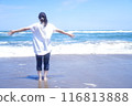 Woman running on sandy beach 116813888