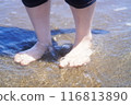 The feet of a woman playing in the sea 116813890