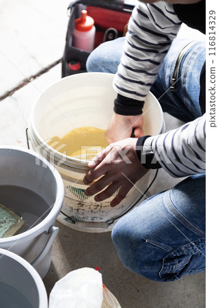 Interior construction: A craftsman mixing putty Interior construction: A craftsman mixing putty 116814329