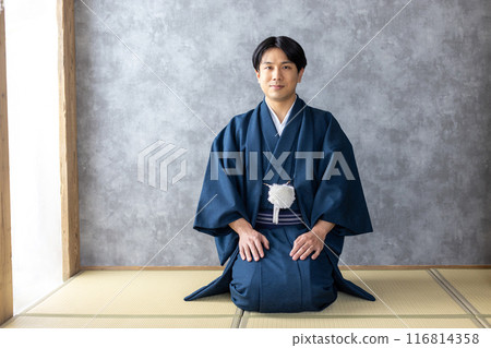 A man wearing a kimono and sitting upright 116814358