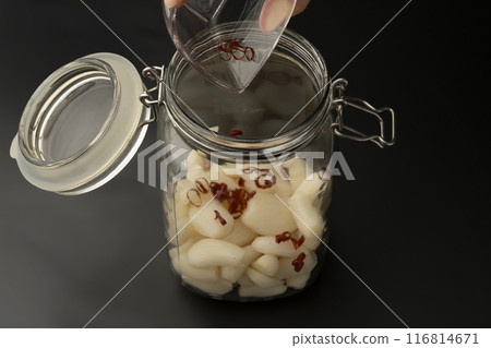 Pickling shallots: Place shallots and chili peppers in a jar Pickling shallots: Place shallots and chili peppers in a jar 116814671