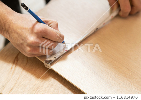 Interior construction: A craftsman marking the wall 116814970
